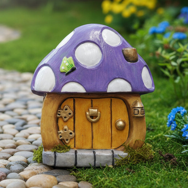 A small mushroom-shaped decorative house figurine with a lilac cap, white  dots, a light brown wooden door, and a grey stone base