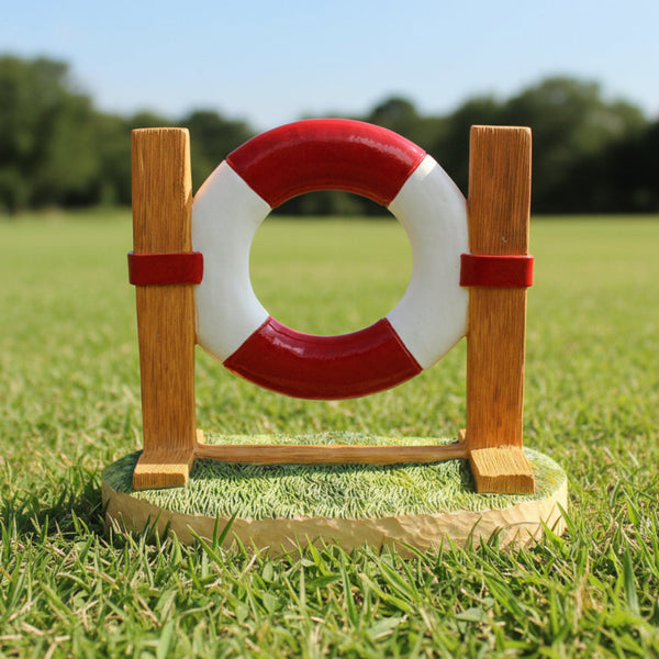 A figurine depicting a red and white lifebuoy with a wooden jump platform on a grass-like surface.