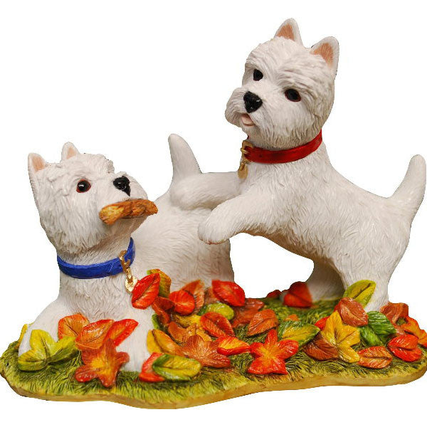 Autumn westies playing in Leaves
